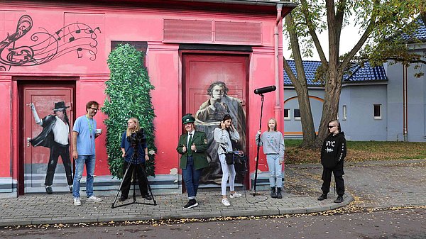 Kinder posieren in Kostümen und mit Filmausstattung 